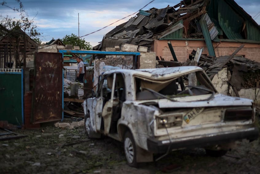A local resident is seen near his building destroyed by Russian missile strike, amid Russia's invasion on Ukraine, in the town of Pokrovsk, in Donetsk region, Ukraine June 15, 2022. REUTERS/Gleb Garanich  A man surveys wreckage of war in Ukraine. — Reuters file photo
