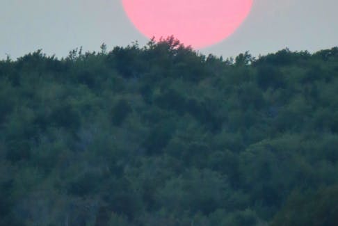 Wildfire smoke enhanced this vivid sunset Judith Brennan captured in Little Bras d’Or, N.S. last week. - Contributed
