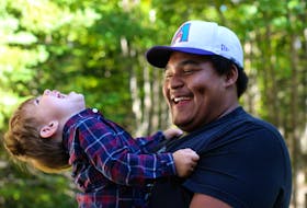 Flashing a big smile and those trademark dimples, Jadon Robinson and his nephew Christopher Pyne share a joyful moment in this photograph taken years ago. The Yarmouth County teenager died in November 2015 at the age of 17 but through the JStrong Fund created in his memory he continues to spread joy among youth in Yarmouth County. CONTRIBUTED

