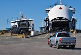 The MV Holiday Island, left, rests crookedly in its berth next to the MV Confederation which will take over providing ferry service to Nova Scotia as of July 28. - Alison Jenkins • The Guardian