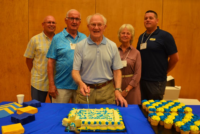 Former Middleton Regional High School (MRHS) principal Al Peppard cuts a cake in his honour during opening ceremonies of the 70th MRHS Reunion July 22. Some other former principals joined him including, from left, Greg Bower, John Galivan, Heather McCormack, and current principal Chad LeBlanc. Lawrence Powell