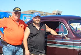 Tyler Gallant, right, is the proud owner of a 1947 Dodge Coup. It belonged to his father, Mike Gallant, before he died in 1998. With help from his uncle Pat Gallant, left, Tyler got the car fixed up, and now enjoys driving it around and taking it to Summerside’s weekly Classic Car Nights. - Kristin Gardiner