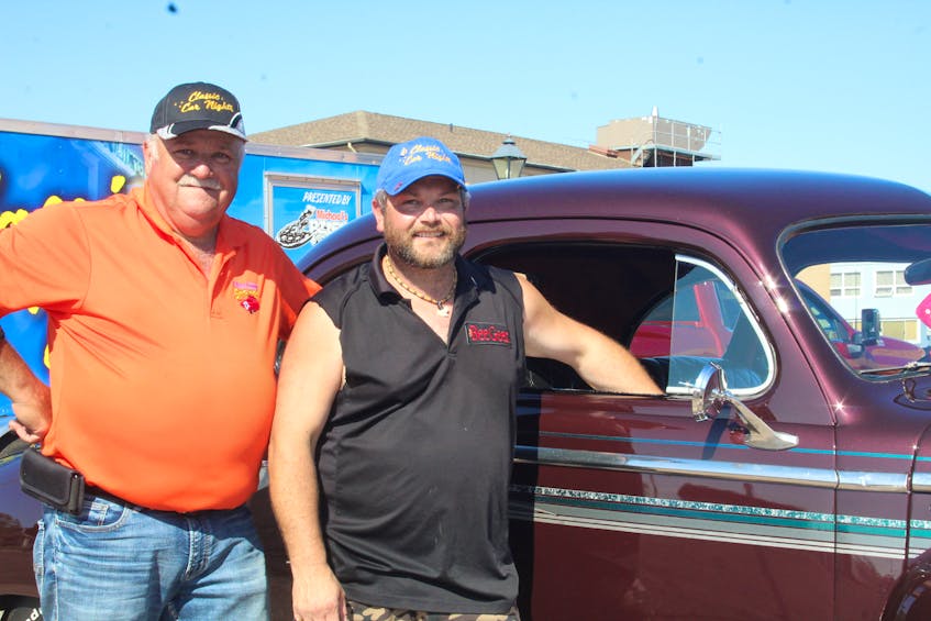 Tyler Gallant, right, is the proud owner of a 1947 Dodge Coup. It belonged to his father, Mike Gallant, before he died in 1998. With help from his uncle Pat Gallant, left, Tyler got the car fixed up, and now enjoys driving it around and taking it to Summerside’s weekly Classic Car Nights. - Kristin Gardiner