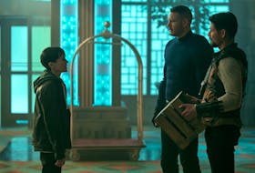 Elliot Page, left, as Viktor Hargreeves in Netflix’s The Umbrella Academy with Tom Hopper as Luther Hargreeves and David Castañeda as Diego Hargreeves in a touching moment where Viktor comes out as Trans.  
NETFLIX 
