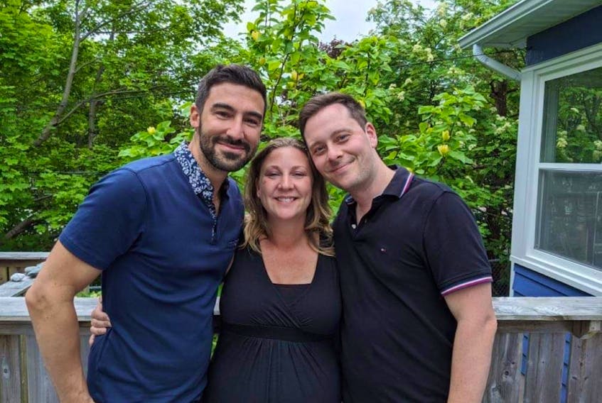 Fathers-to-be Carl Mastrovito, left, and Alexandre Béland of Montreal pose with their surrogate, Lesley Rumsey of St. John's, who will give birth to their first child in November. The dads say they are proud their baby will be born in Newfoundland and are looking forward to sharing the story with her.