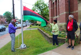 The Pan-African flag was raised outside of Truro's town hall. Pictured are Deputy Mayor Wayne Talbot, community elder Marg Jackson and Mayor Bill Mills.