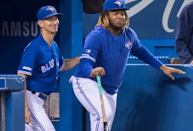 Toronto Blue Jays' Vladimir Guerrero Jr., right, is seen with first base coach Mark Budzinski in Toronto Saturday September 28, 2019. 