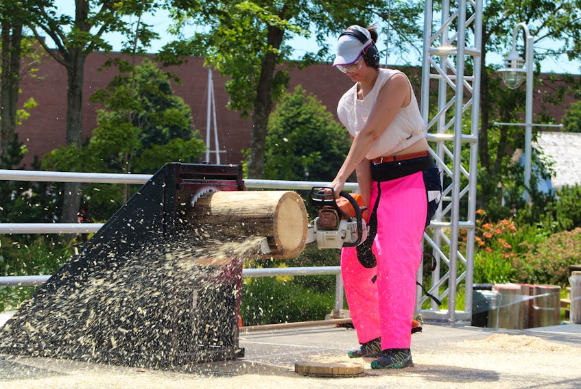 SaltWire Network's Alison Jenkins tries her hand at using a chainsaw July 28 in Charlottetown after some instructions from Stihl Timbersports  2022 Canadian Championship co-host Ryan McIntyre. Ryan Ross • The Guardian