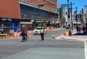 A Halifax Regional Police officer directs traffic on Spring Garden Road as part of a pilot project to limit motor vehicle traffic on the street. While the area between South Park and Queen streets is supposed to be only for buses, cyclists and pedestrians between 7 a.m. and 8 p.m. for the next year, lots of drivers were spotted ignoring the signs Monday.