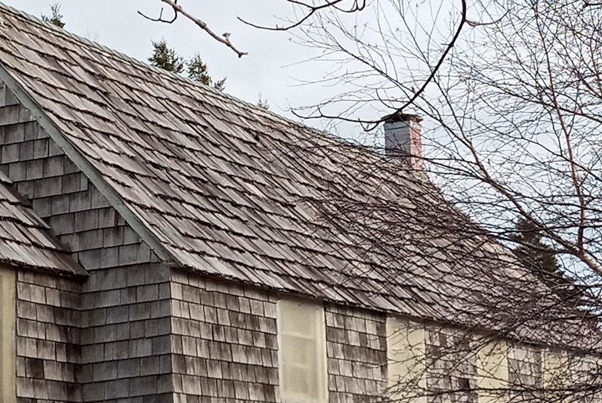 A look at the shingles before work began. American Bradley Jacob Folensbee Jr. was the last person to replace them, in the early 1980s, with imported western red cedar shingles. Measuring two-and-a-half inches thick at one end, it made finding similar shingles for the replacement a challenge. - Rex Passion photo