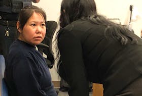 Accused murderer Lorraine Obed, 29, speaks with defence lawyer Sarah Evans in provincial court in St. John's on Monday, July 4, at the start of her preliminary inquiry.