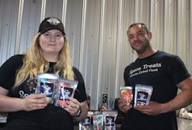 Brooke Wagner, left, and her partner Lee Pullia hold up bags of candy that the pair freeze-dried for their business, Space Treats Freeze Dried Food. - Kristin Gardiner