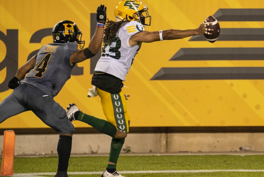 Hamilton Tiger-Cats wide receiver Papi White (4) cannot catch Edmonton Elks defensive back Jalen Collins (33) from running the ball into the end zone after recovering a fumble by Ticats quarterback Dane Evans (9) late in the fourth quarter  in Hamilton, Ont., Friday, July 1, 2022.