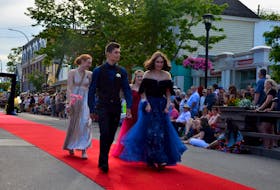 Cedric Van Exel, Tia Dodge, Katrina Guptil and Brooke Fike march down the red carpet on Main Street in Wolfville as graduates from Horton High School’s Class of 2022 were celebrated on June 23. KIRK STARRATT