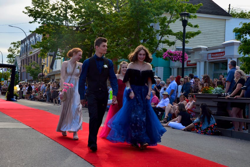 Cedric Van Exel, Tia Dodge, Katrina Guptil and Brooke Fike march down the red carpet on Main Street in Wolfville as graduates from Horton High School’s Class of 2022 were celebrated on June 23. KIRK STARRATT