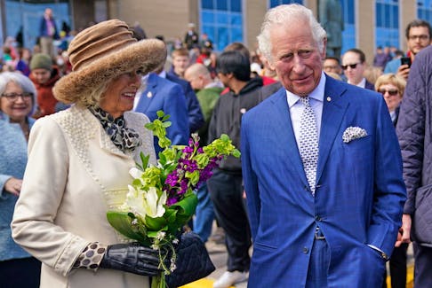 The Prince of Wales and Duchess of Cornwall at the Confederation Building in St. John's on May 17. The Duchess holds a flower bouquet given to her by Premier Andrew Furey’s children. Flowers and planters for the royal visit cost the provincial government about $5,400. -PA via Reuters