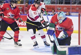 Team White's Nathan Gaucher of the Quebec Remparts tries to tip the puck past Team Red goalie Reid Dyck of the Swift Current Broncos during the 2022 Kubota CHL/NHL Top Prospects game in Kitchener, Ontario on Wednesday, March 23, 2022.
 