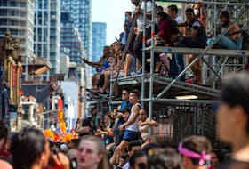 Spectators take in the view of the Toronto Pride Parade on Sunday June 26, 2022. A new report revealed that the highest level of Omicron infection was found in young adults, aged 17 to 24.