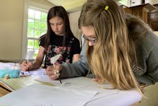 Students from Forest Ridge Academy try writing with quill pens at the Old Meeting House Museum in the Barrington Museum Complex. KATHY JOHNSON