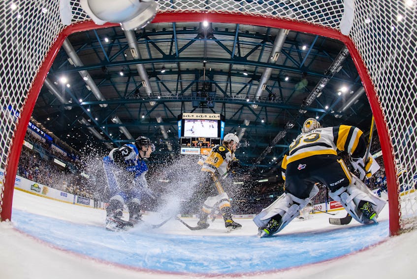 Saint John Sea Dogs forward Brady Burns, left, puts on the brakes in front of the Hamilton Bulldogs net during the Memorial Cup final.