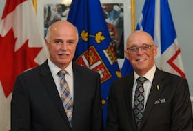 After swapping cabinet portfolios, Health Minister Tom Osborne and Education Minister John Haggie pose for a photo at Government House on Wednesday. -Joseph Gibbons/SaltWire Network