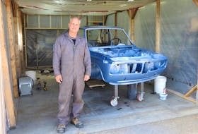 Thane Walton in his 30x30-foot workshop with his spray booth and the 1972 BMW 2002tii. Having made tremendous progress since the fall of 2021, he says he’s pressing pause on the restoration for the summer and will begin bolting it back together this fall. Contributed photo/Thane Walton