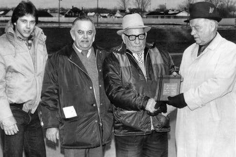 Bob Dewar, right, makes a presentation to three generations of the Stead family — Sid Jr., Sid and Harold. PHOTO CREDIT: Contributed