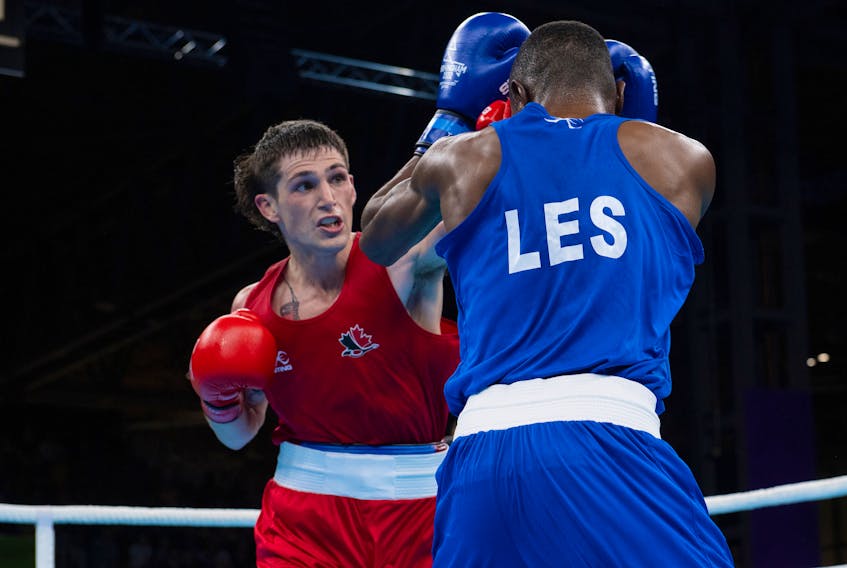 Canada's Wyatt Sanford, left,  of Kennetcook lands a punch on Qhobosheane Mohlerepe of Lesotho in South Africa at the Commonwealth Games on Sunday in Birmingham, England. - Dan Galbraith/Commonwealth Sport Canada