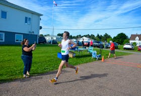 Jack Roberts of Charlottetown is all smiles as he crosses the finish line in the 45th running of the Dunk River Road Race in Bedeque on July 31. Roberts, the race’s overall winner, finished in a time of 40 minutes 43 seconds (40:43). Jason Simmonds/Journal Pioneer