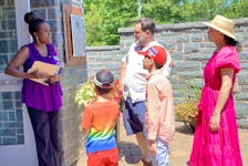 Andrea Davis, the new executive director of the Black Loyalist Heritage Centre (left) in Birchtown greets a family visiting the centre during Journey Back to Birchtown. KATHY JOHNSON

