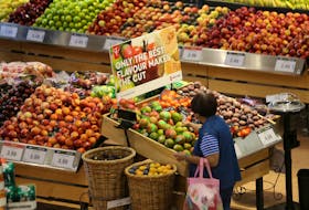 FILE PHOTO: A woman browses in the fruit section of a Loblaw supermarket in Collingwood, Ontario, Canada July 28, 2017.  REUTERS/Chris Helgren/File Photo  A woman browses in the fruit section of a Loblaw supermarket in Collingwood, Ont. REUTERS/Chris Helgren/File Photo