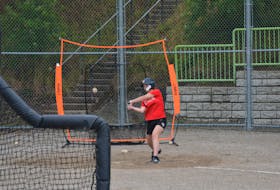 Newfoundland and Labrador’s Cecily Davis swings at a ball during batting practice at the Edgar Hartery Field in St. John’s on Wednesday. Nicholas Mercer/The Telegram