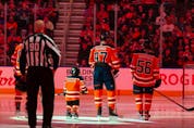 Five-year-old Scotiabank Skater Ben Stelter stands with the Edmonton Oilers and the San Jose Sharks during the national anthems at a NHL game at Rogers Place in Edmonton on March 24, 2022. 