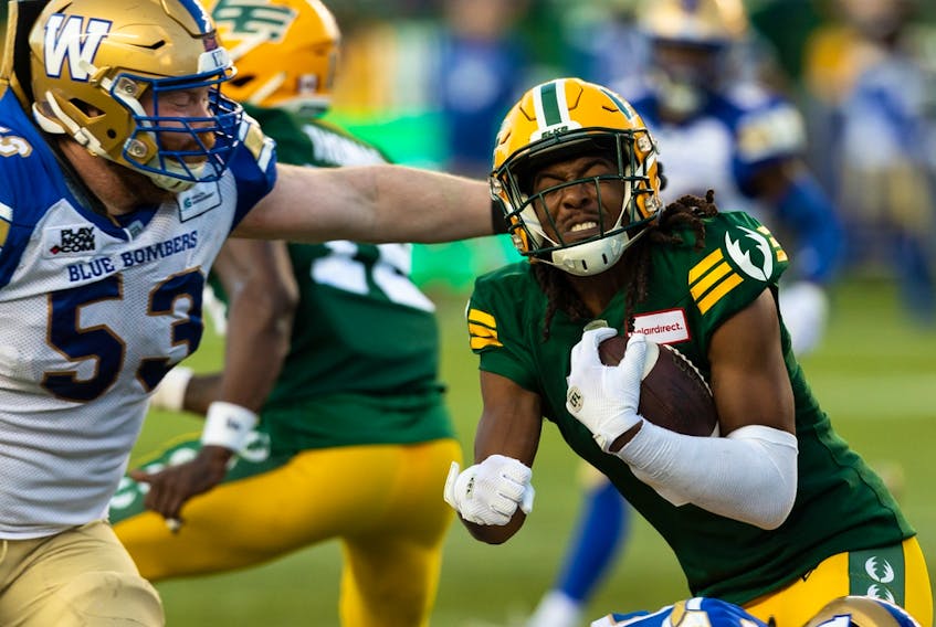 Edmonton Elks defensive back Duron Carter (8) is tackled by the Winnipeg Blue Bombers’ Patrick Neufeld (53) after an interception at Commonwealth Stadium in Edmonton on July 22, 2022.