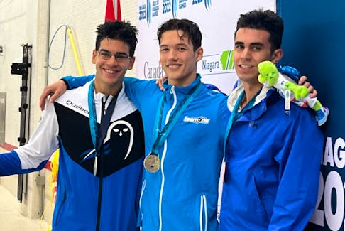 Halifax's Keilen Bellis (centre) captured his second gold medal of the Canada Games on Wednesday. Bellis, shown here flanked by Sinan Onur of Quebec (left) and Jett Verjee of Alberta, won the 100-metre breaststroke in 1:06.06. - TEAM NOVA SCOTIA