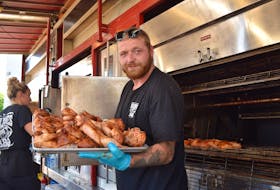 Chris McDermott tempts the tastebuds with this tray of barbecued Billy Bones BBQ chicken at the Pictou County Ribfest at Glasgow Square. Ray Burns - The News