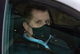 Former Vancouver Whitecaps and Canada U-20 women's soccer coach Bob Birarda leaves his lawyer's office in a vehicle after appearing in provincial court via a video link, in Vancouver, on Feb. 8, 2022. 