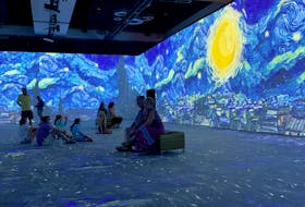People take in the Van Gogh P.E.I. immersive art exhibit in Charlottetown on Aug. 7. The 360-degree rendering of the Dutch artist's work opened at the P.E.I. Convention Centre on Aug. 5, where it will be on display until Sept. 5. The Guardian