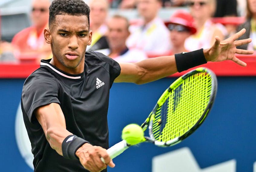 Montreal's Félix Auger-Aliassime hits a return agains Casper Ruud of Norway during quarter-final action at IGA Stadium on Friday.