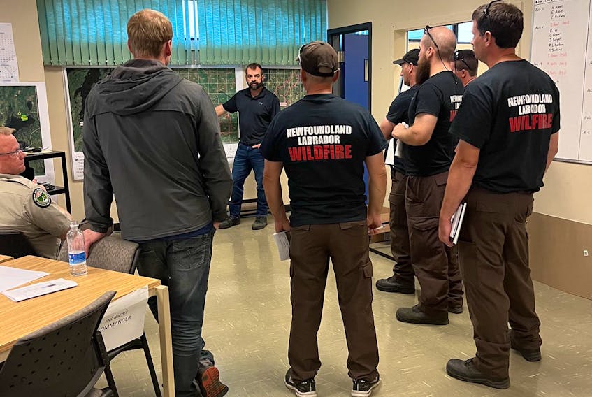 A new crew of firefighters take part in a debriefing on the Bay d’Espoir forest fire at the fire centre in Gander on Thursday, Aug. 11. – Fisheries, Forestry and Agriculture Photo