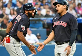 Cleveland Indians first baseman Josh Naylor (22) is greeted by shortstop Amed Rosario (1) after hitting a home run against the Toronto Blue Jays at Rogers Centre. 