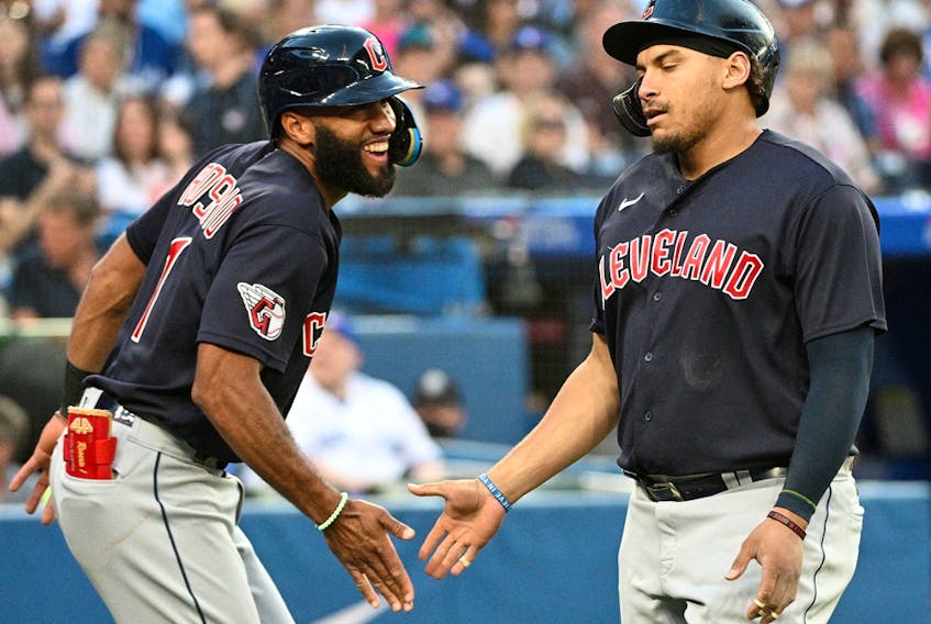 Cleveland Indians first baseman Josh Naylor (22) is greeted by shortstop Amed Rosario (1) after hitting a home run against the Toronto Blue Jays at Rogers Centre. 
