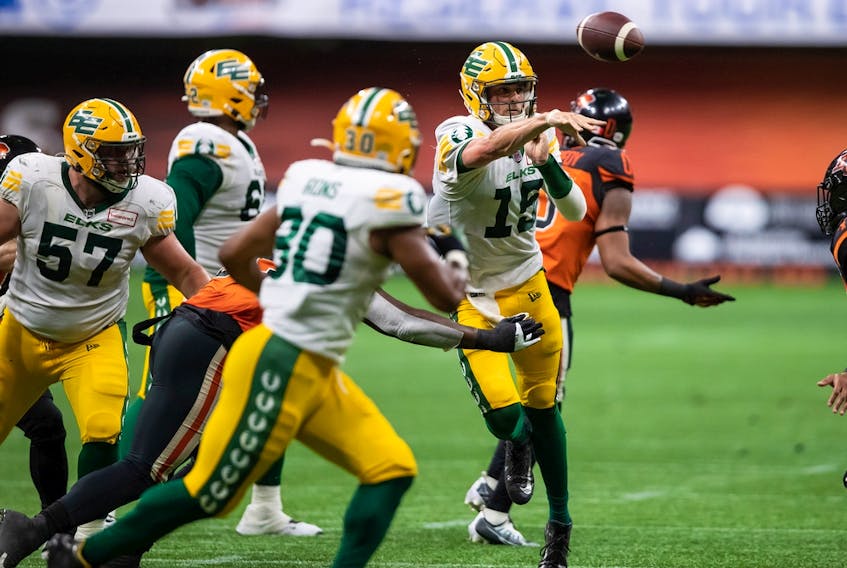 Edmonton Elks quarterback Taylor Cornelius passes during the second half of a CFL football game against the B.C. Lions in Vancouver on Aug. 6, 2022.