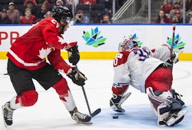 Canada's Mason McTavish (23) scores a goal against Czechia's goalie Tomas Suchanek (30) during second period IIHF World Junior Hockey Championship action in Edmonton on Saturday, Aug. 13, 2022.
