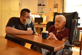 Resident care worker Kaelin Fisher helps resident Leonard Martin with a drink of water at Prince Edward Home Aug. 8. Alison Jenkins • The Guardian
