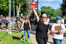 Jillian Ford-King and Yvetter Saulnier lead the Acadian Day "tintamarre" (noise parade) from Truro town hall on Aug. 14.