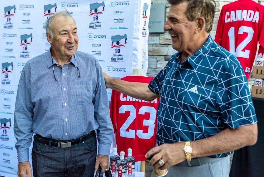 Former Montreal Canadiens and Team Canada teammates Guy Lapointe and Serge Savard, right, chat at the third edition of the Serge Savard Invitational golf tournament at Le Mirage golf club in Terrebonne on Aug. 16, 2022.