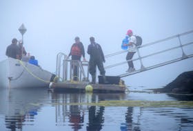 Volunteers board an outboard at The Hawk, Cape Sable Island, bound for the Cape Ledge for a shoreline cleanup of the small offshore island on Aug. 6 and 7. KATHY JOHNSON