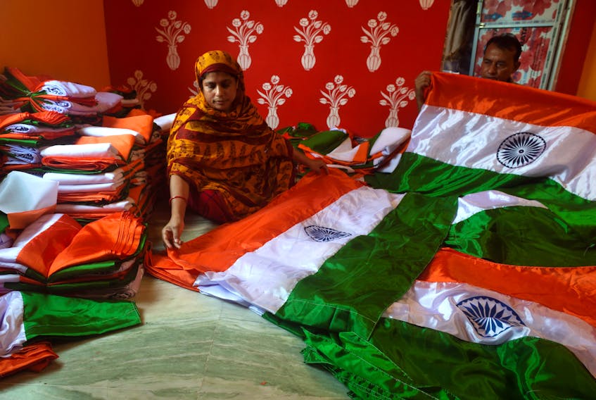 Workers fold Indian flags at flag making workshop in Kolkata, India on Aug. 2 as part of a campaign to commemorate the 75th anniversary of India’s Independence. Sukhomoy_ Sen/Eyepix Group via Reuters
