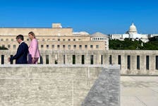 Steven Guilbeault walks alongside Canada’s ambassador to the U.S., Kristen Hillman, atop the Canadian embassy with the Capitol Building in the background. — Contributed photo